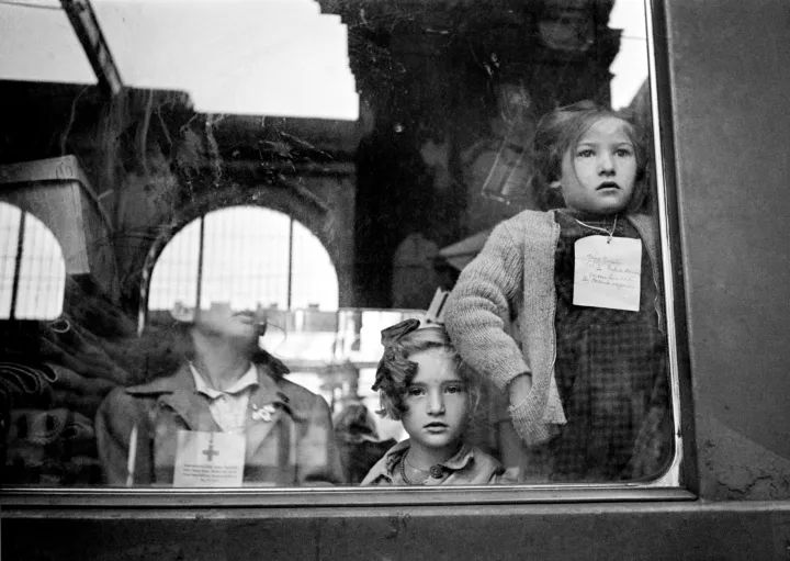 HUNGARY. Budapest. 1947. Keleti train station. Children are sent to Switzerland for three months, each with a tag around the neck indicating name and belongings. The ‘Children’s train’ leaves Switzerland about once every three months, traveling to Budapest via Vienna. Passing through these capital cities, the train delivers the most urgently needed provisions and then, on the return trip, takes on about 50 weary children from each city for three months of recuperative vacation.