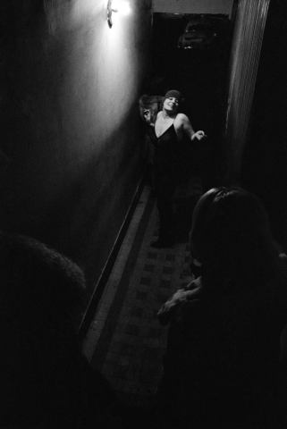 Blondine dances in the hallway. La Rue des Lombards, Paris, France, 1976-1977 © Jane Evelyn Atwood